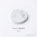 Pebble-shaped diatomite coaster with marble pattern on a white background with text 'Pebble Marble 2pcs printed pattern'