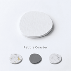 Pebble coasters in various designs on a light gray background