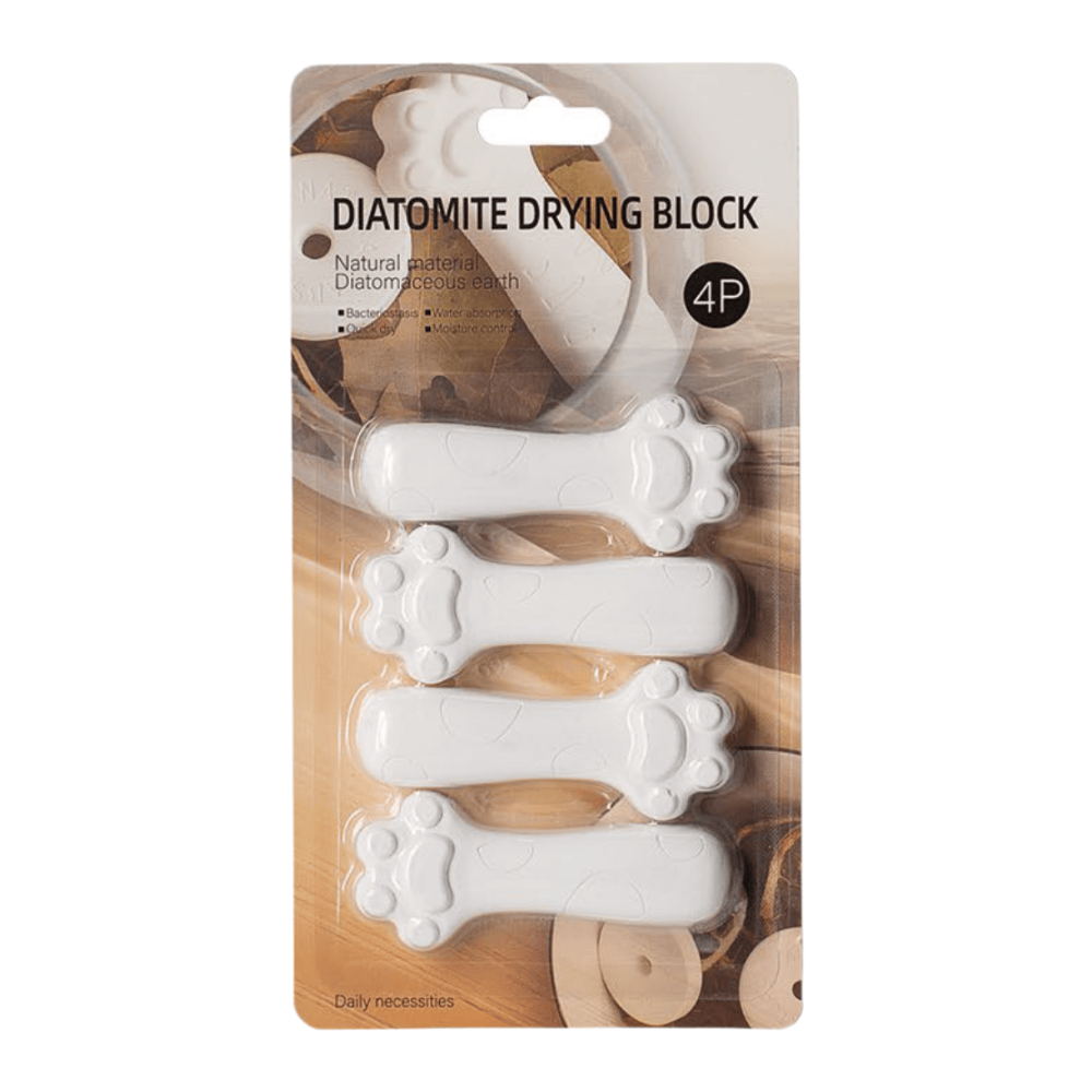 Packaging of four white paw-shaped Diatomite Drying Blocks on White background